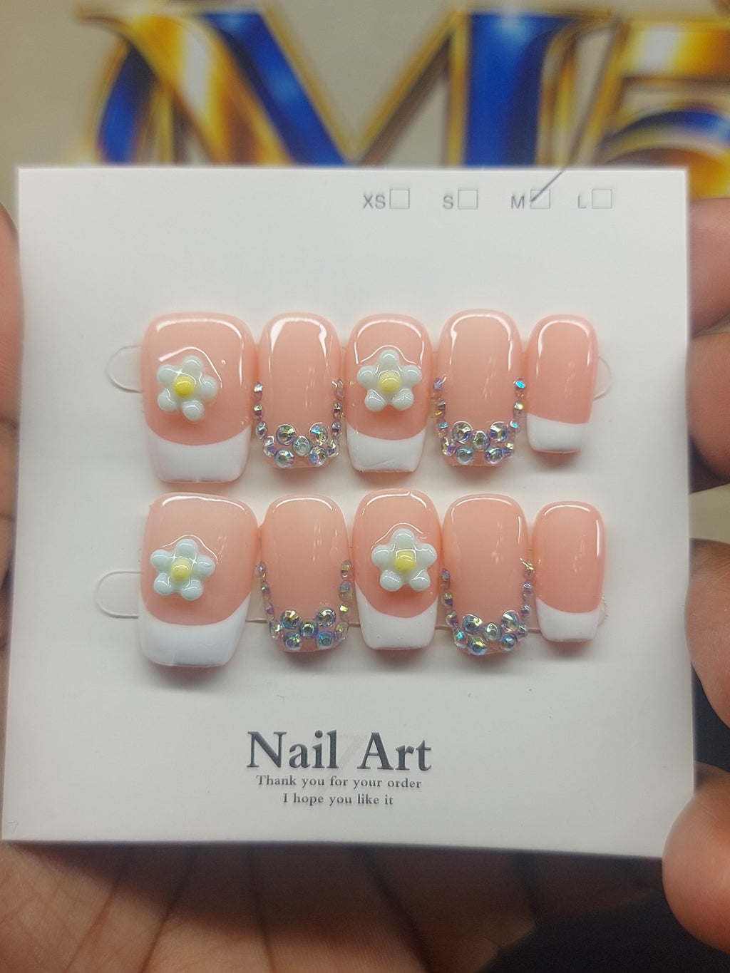 Peach Daisy Glam nails close-up
