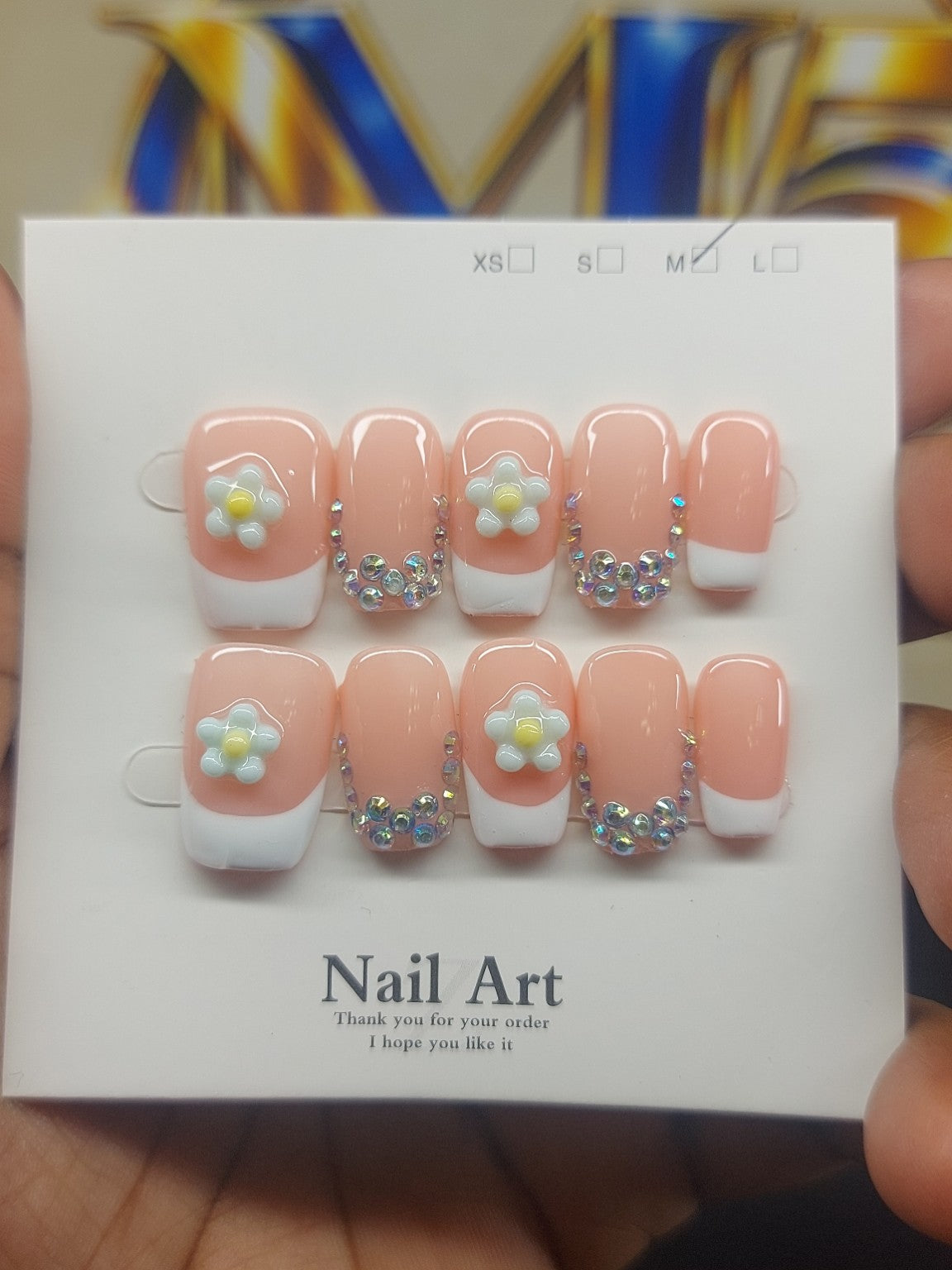 Peach Daisy Glam nails close-up