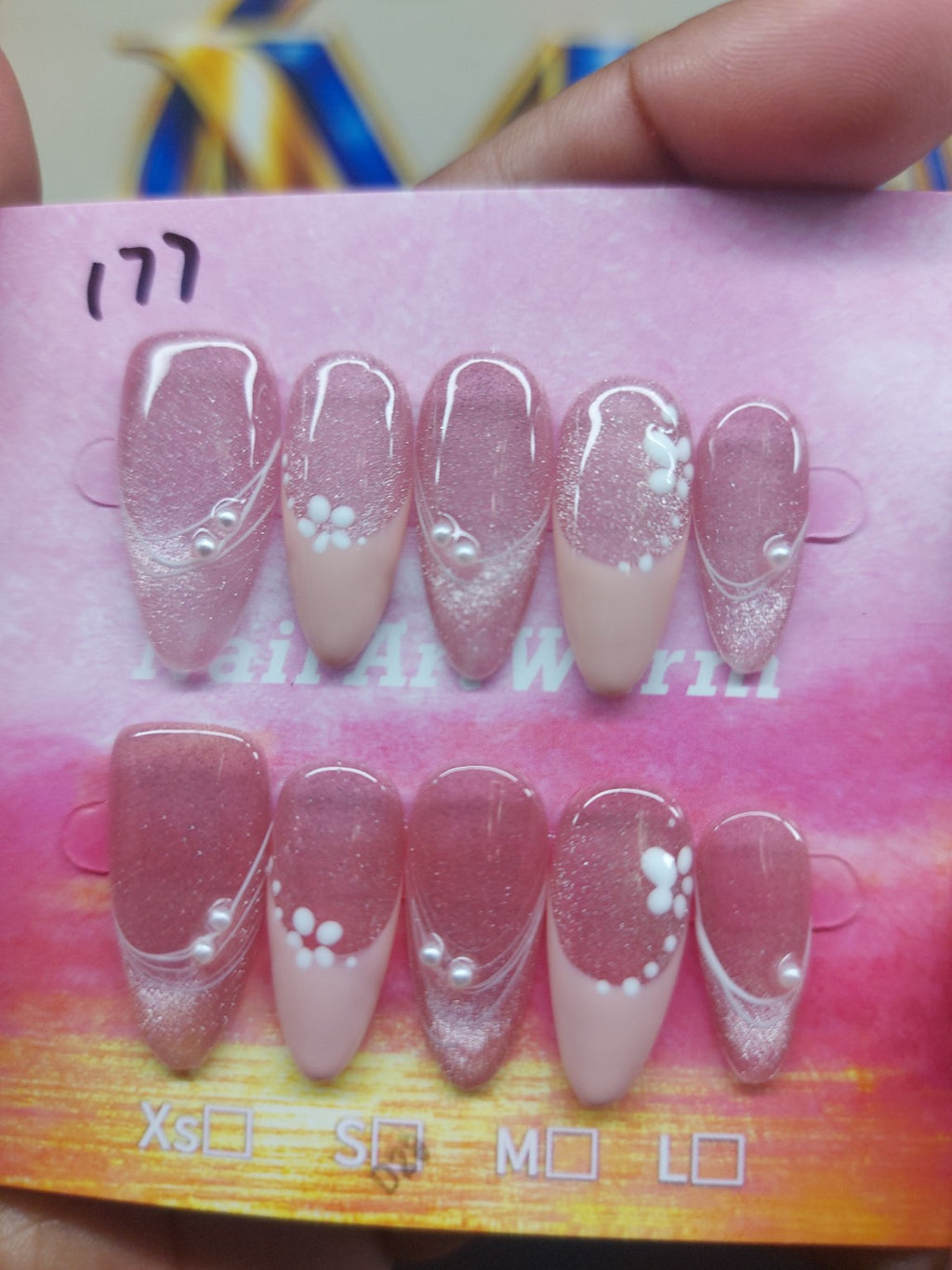 Rose pink glitter floral nails close-up