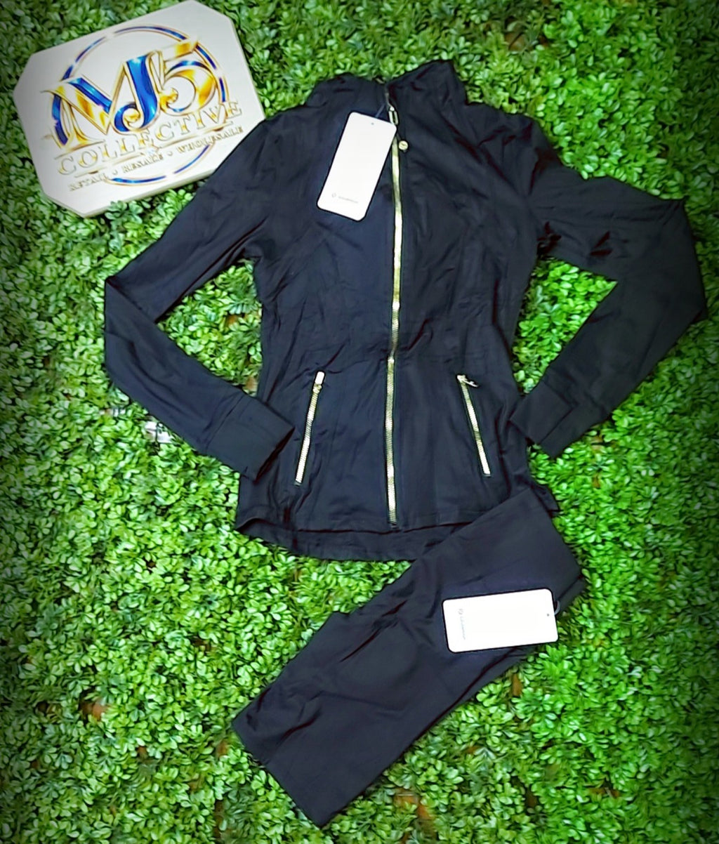 Black jacket with gold zippers and matching biker shorts, original product photo