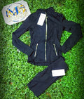 Black jacket with gold zippers and matching biker shorts, original product photo