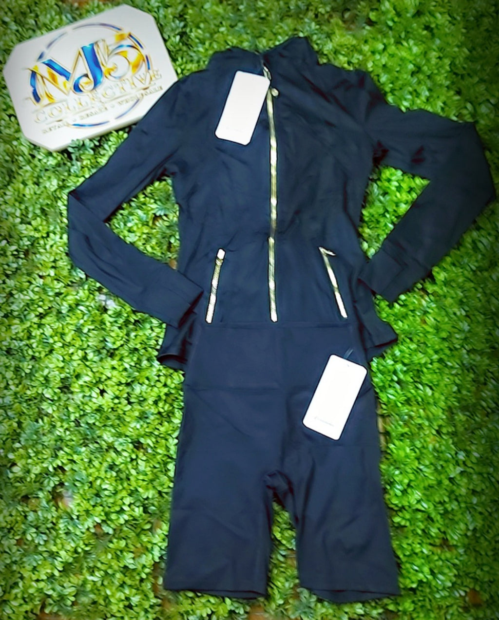 Black jacket with gold zippers and matching biker shorts, original product photo