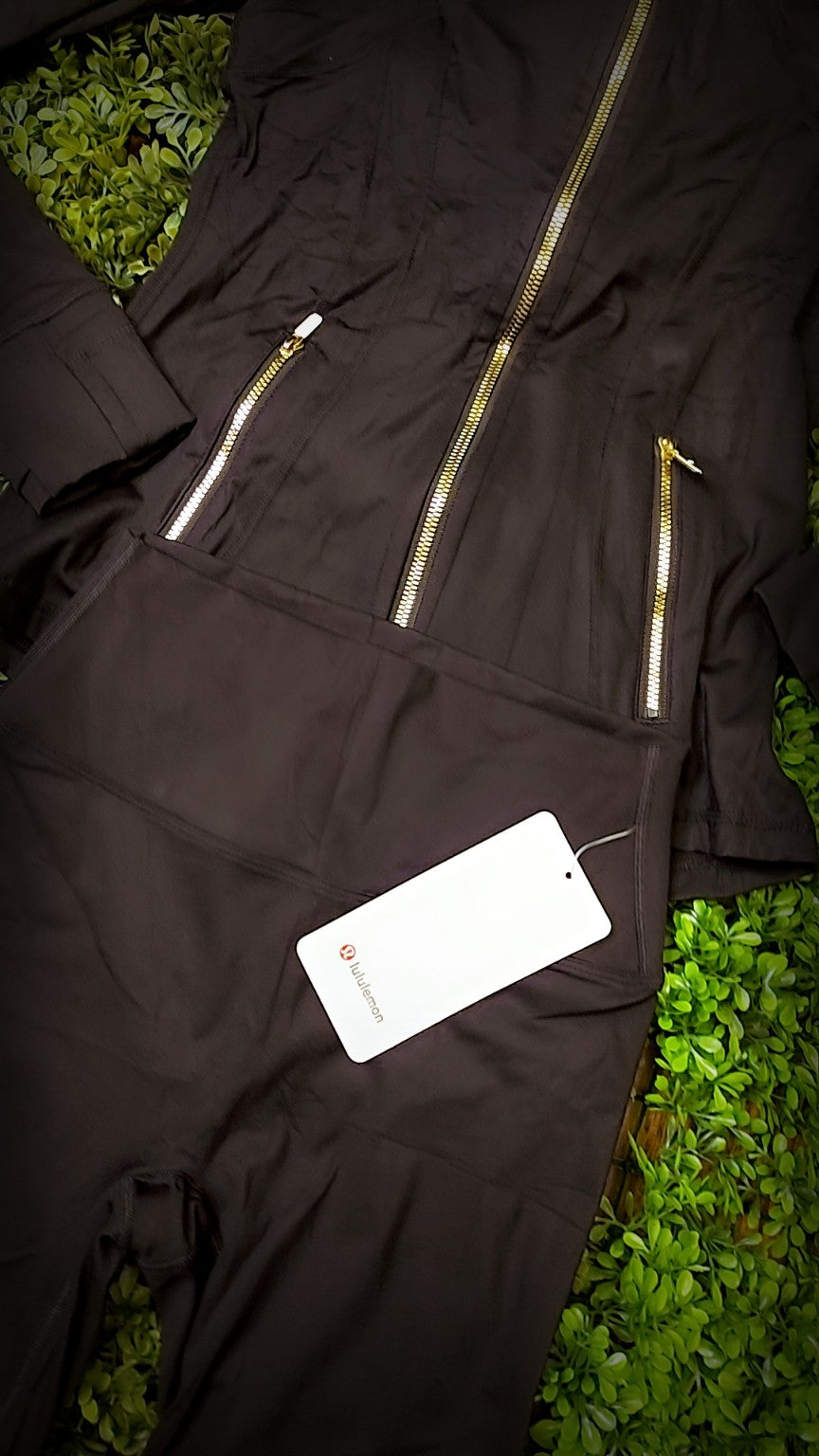 Black jacket with gold zippers and matching biker shorts, original product photo