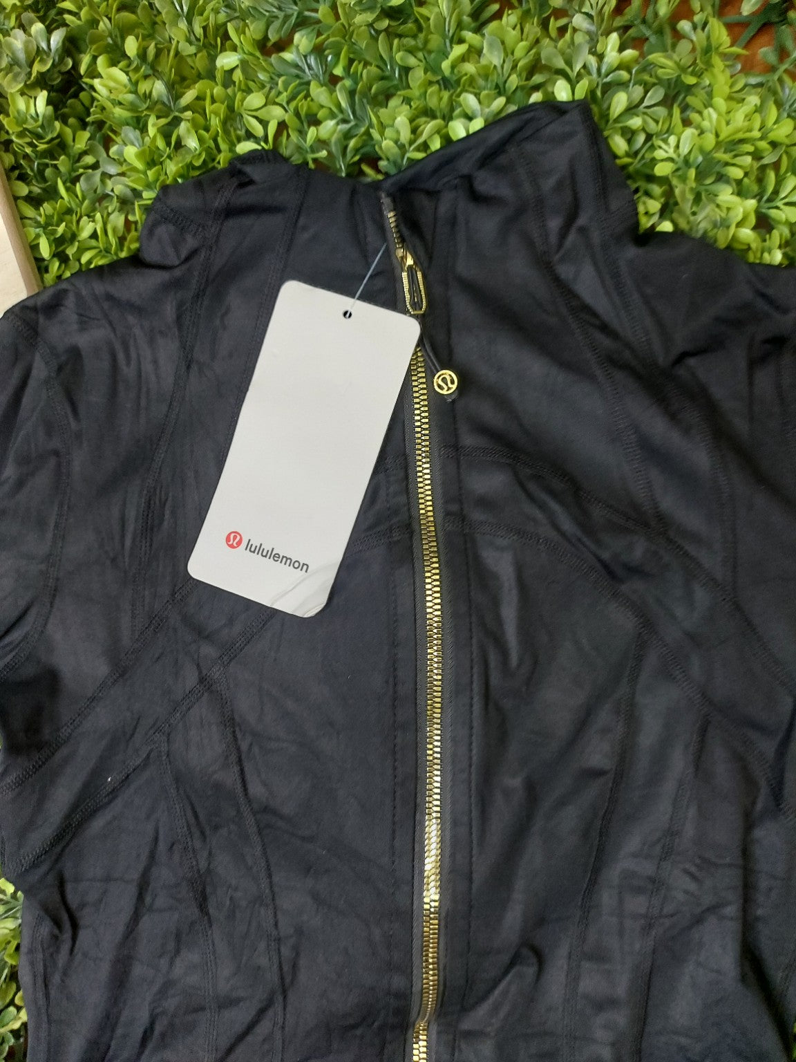 Black jacket with gold zippers and matching biker shorts, original product photo