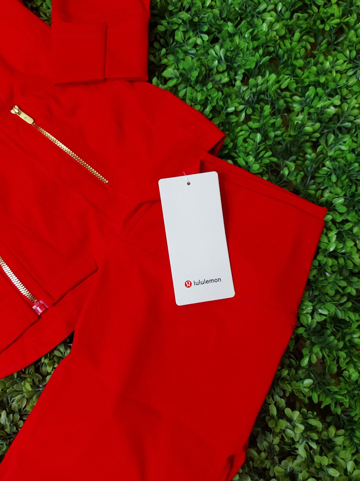 Red jacket with gold zippers and matching leggings, original product photo