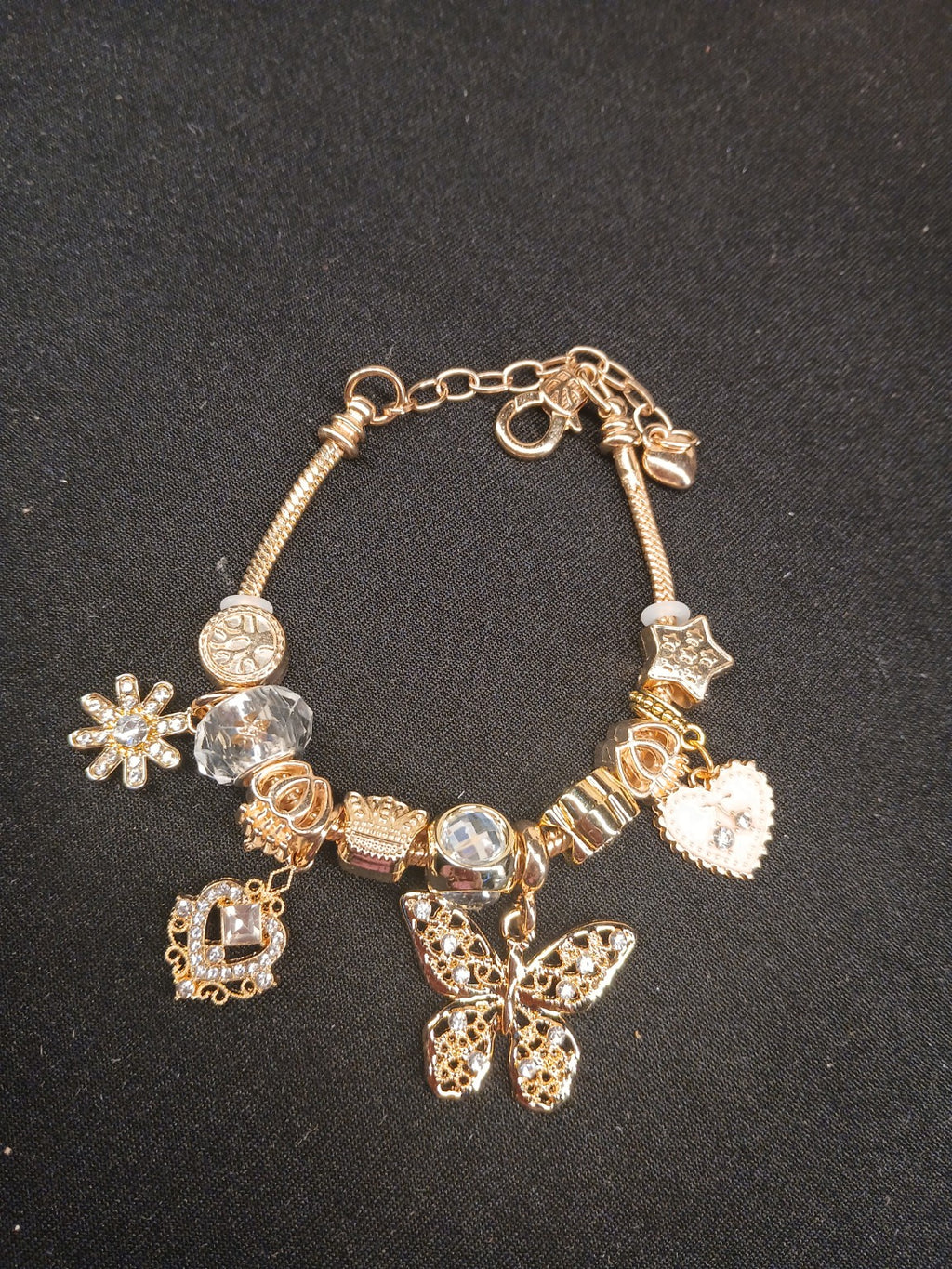 Golden Butterfly Wishes Charm Bracelet close-up on black background