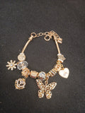 Golden Butterfly Wishes Charm Bracelet close-up on black background