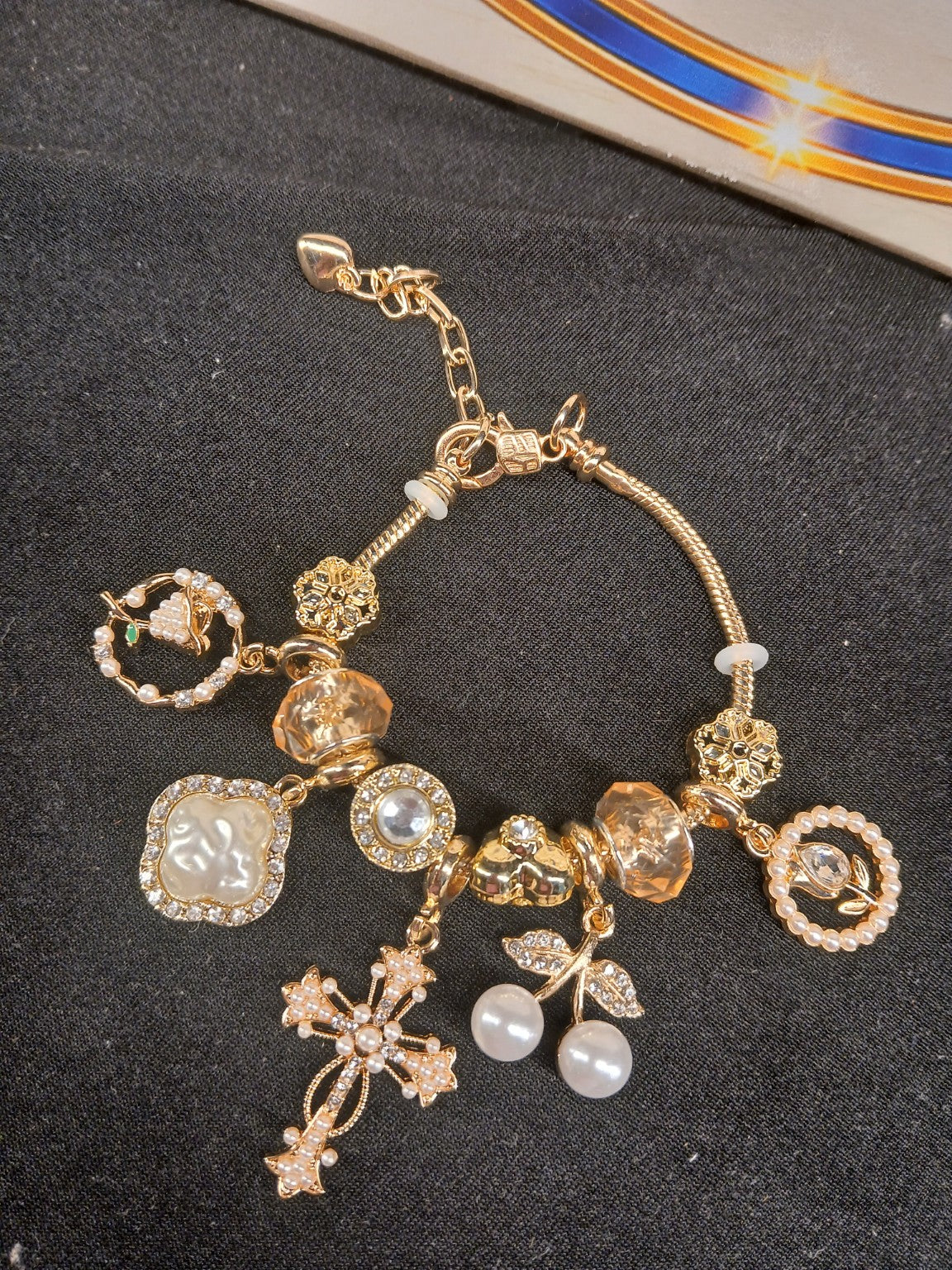 Golden Pearl Grace Charm Bracelet close-up with pearl and gold details