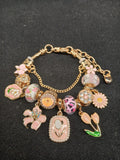 Blush Garden Charm Bracelet close-up with pink flowers and gold details