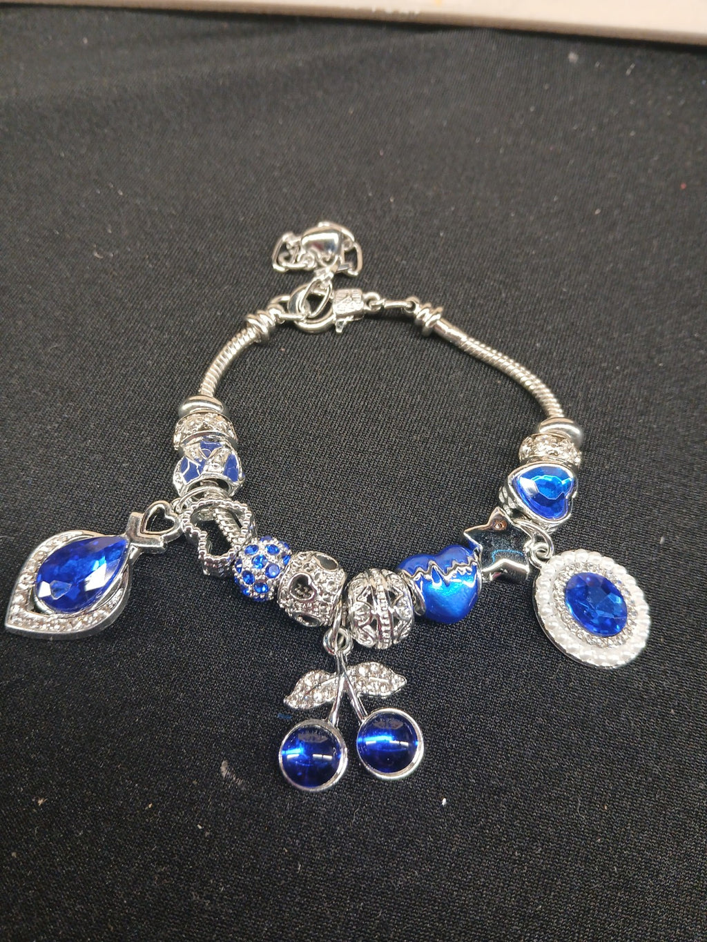 Sapphire Blue Cherry Sparkle Charm Bracelet close-up with blue cherries and silver charms