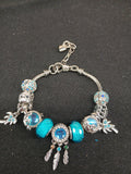 Turquoise Dreamcatcher Sparkle Charm Bracelet close-up with turquoise beads and feathers