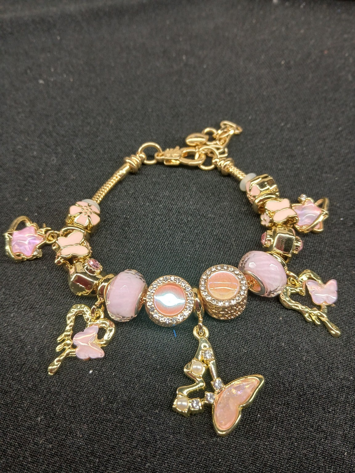 Blush Butterfly Garden Charm Bracelet close-up with pink butterfly and flower charms
