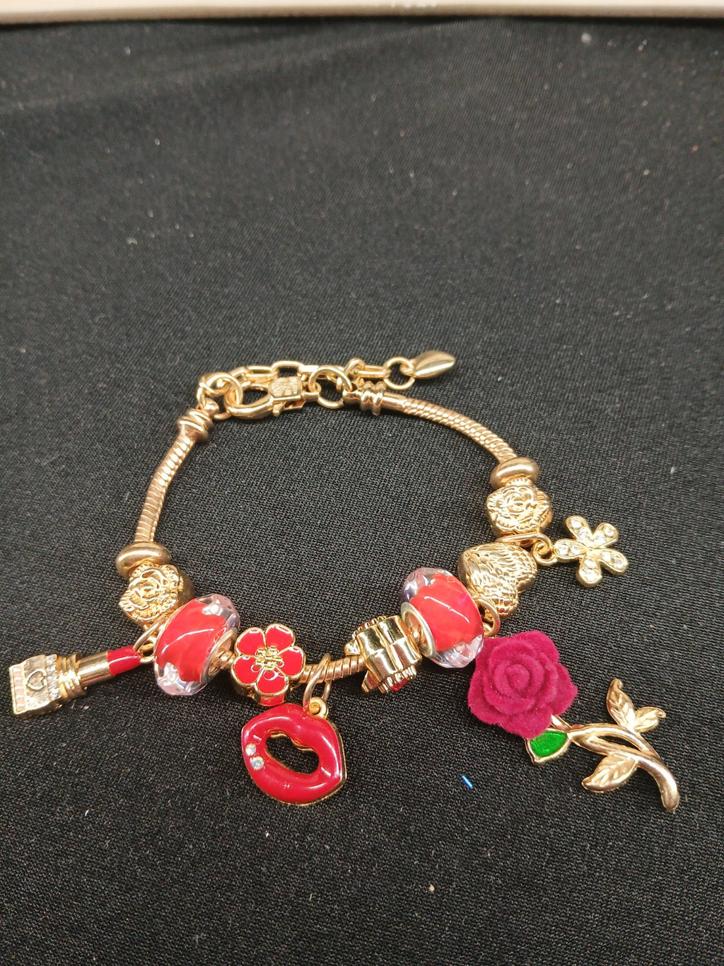 Ruby Rose Kiss Charm Bracelet close-up with red lips and rose charms