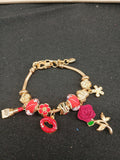 Ruby Rose Kiss Charm Bracelet close-up with red lips and rose charms