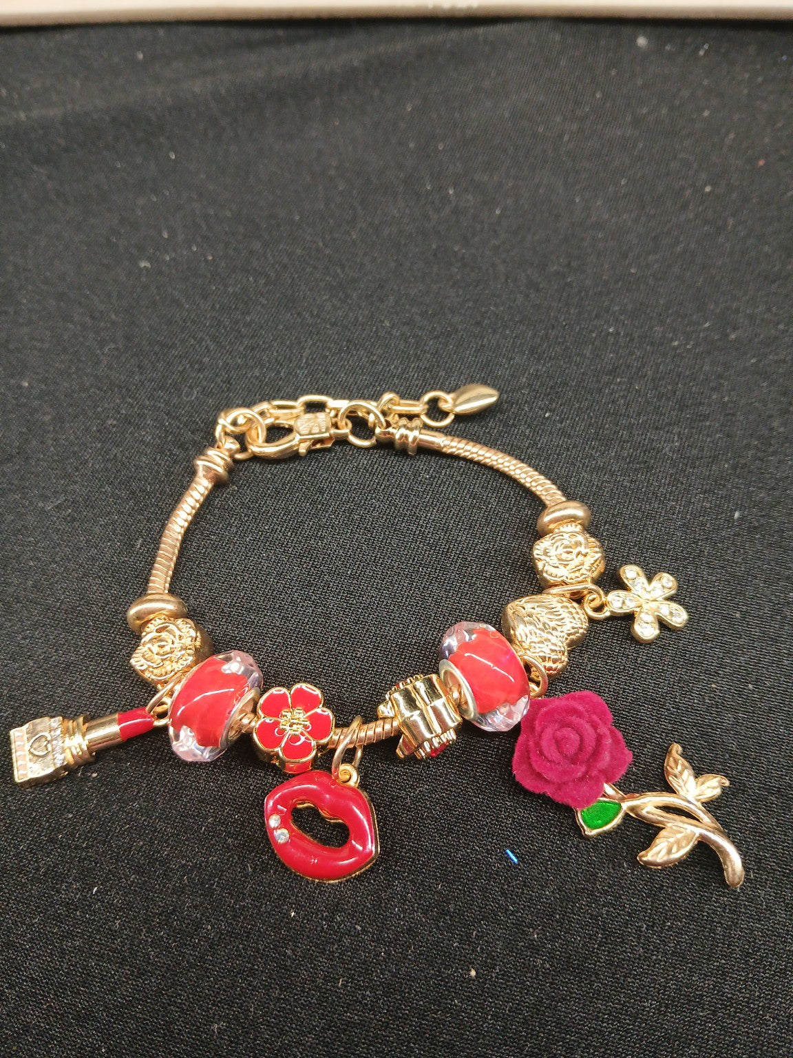 Ruby Rose Kiss Charm Bracelet close-up with red lips and rose charms