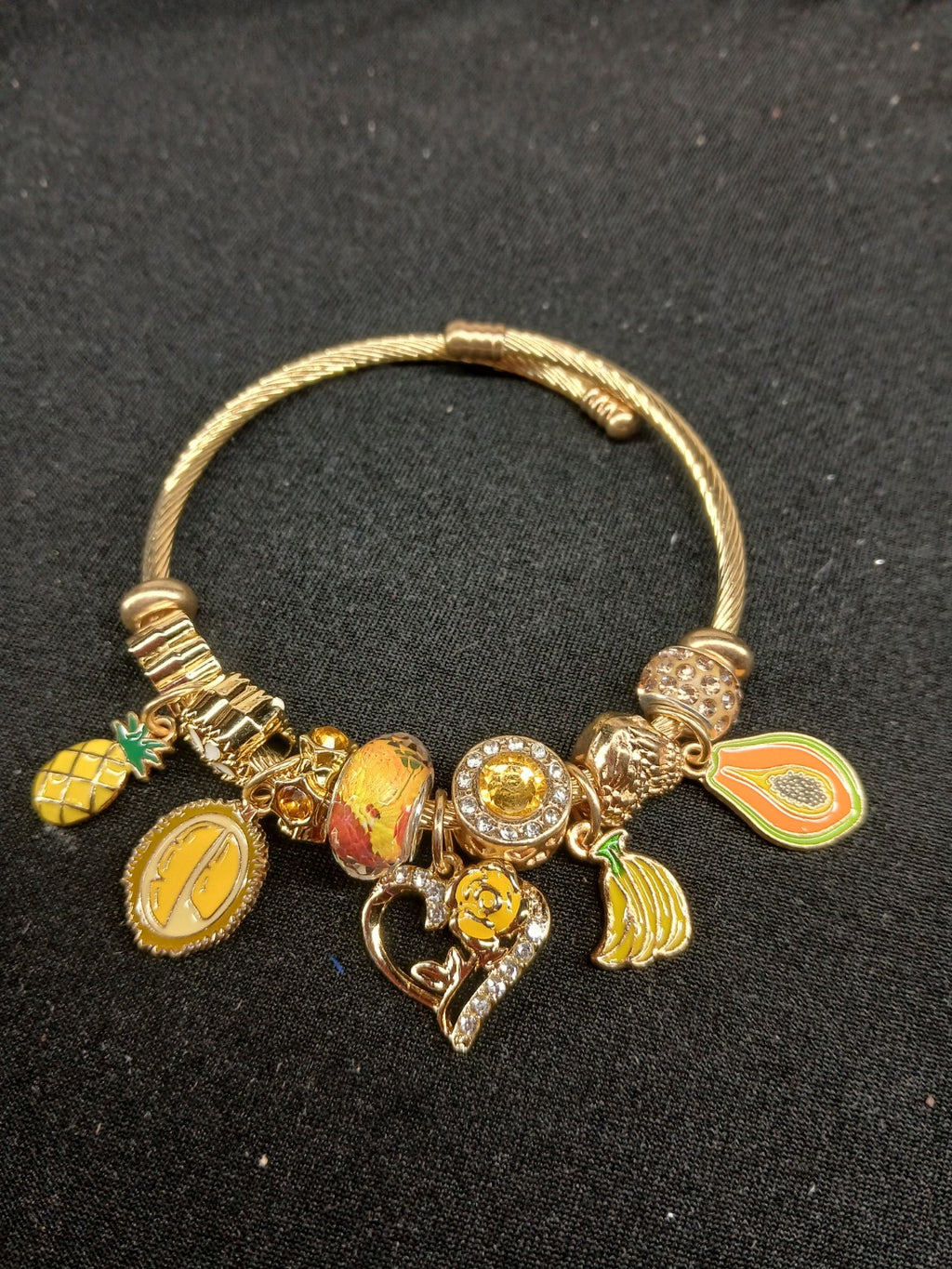 Tropical Golden Sunshine Charm Bracelet close-up showing fruit and yellow rose charms
