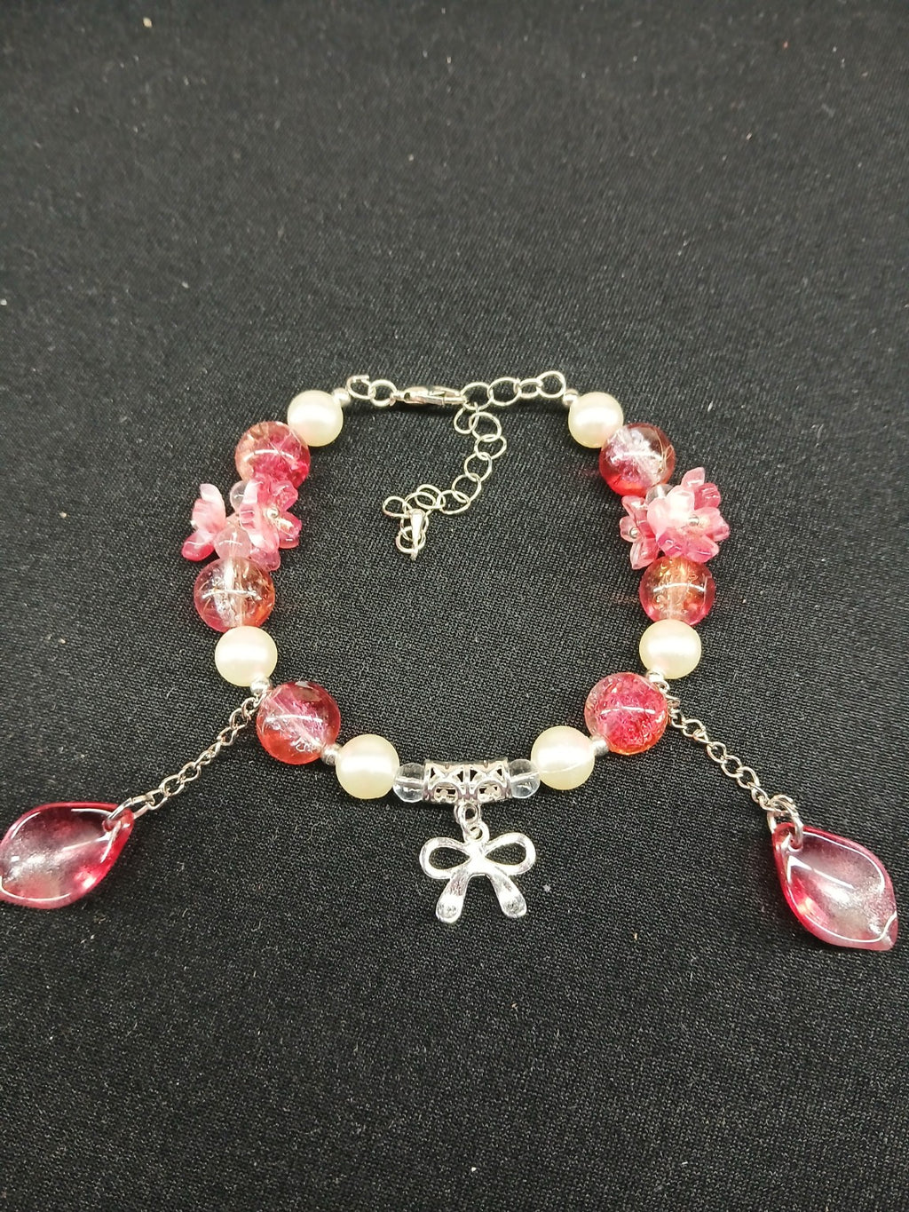 Pink floral and pearl bow bracelet close-up