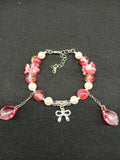 Pink floral and pearl bow bracelet close-up