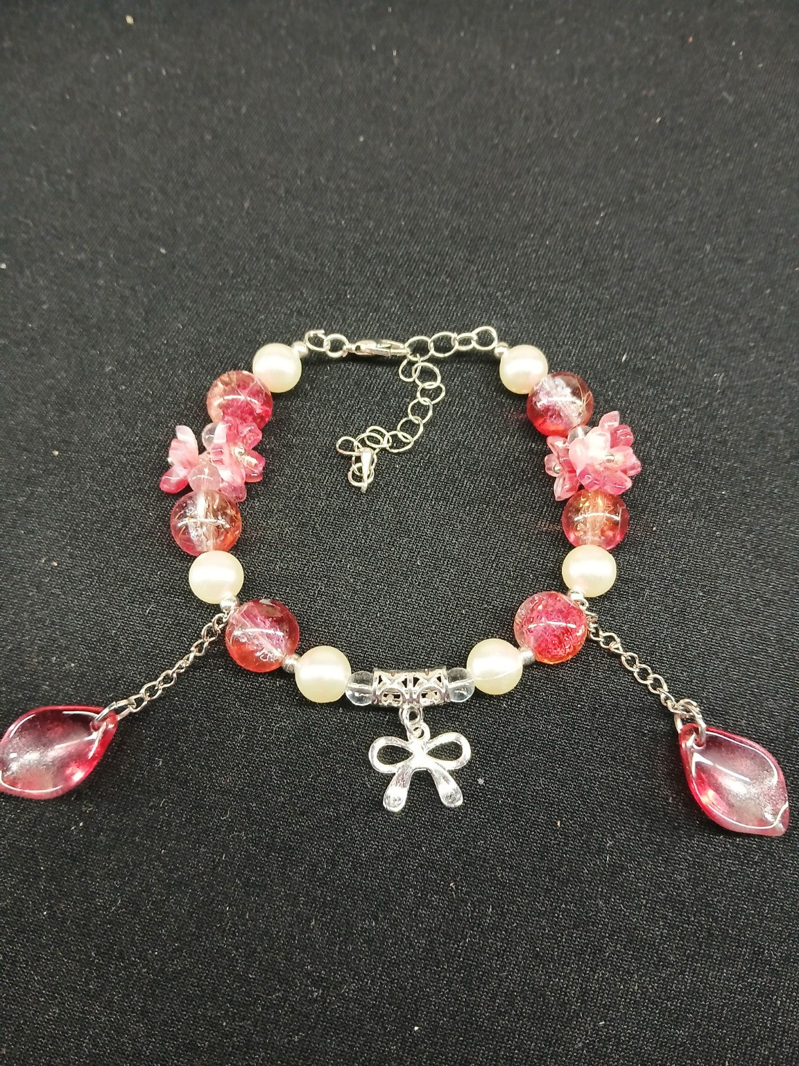 Pink floral and pearl bow bracelet close-up