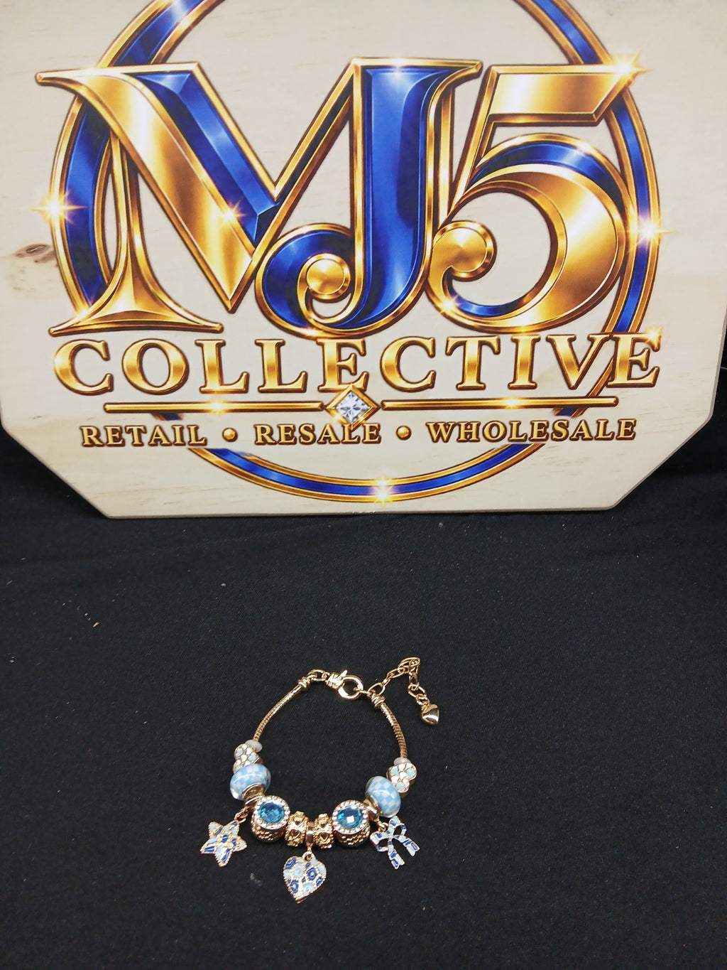 Full view blue and gold charm bracelet