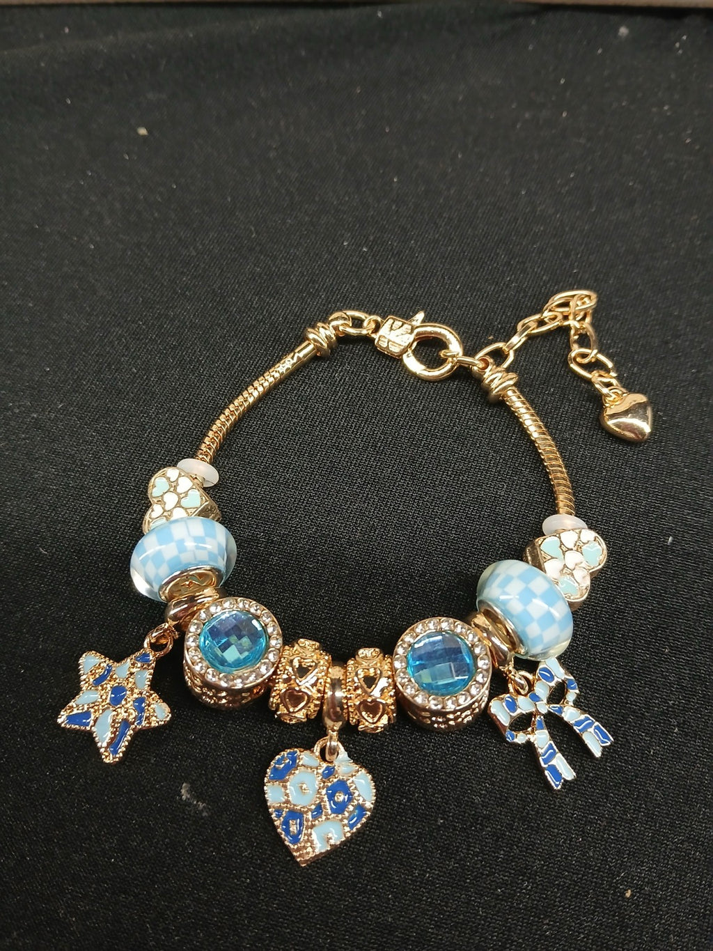 Close-up blue and gold charm bracelet