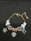 Close-up blue and gold charm bracelet