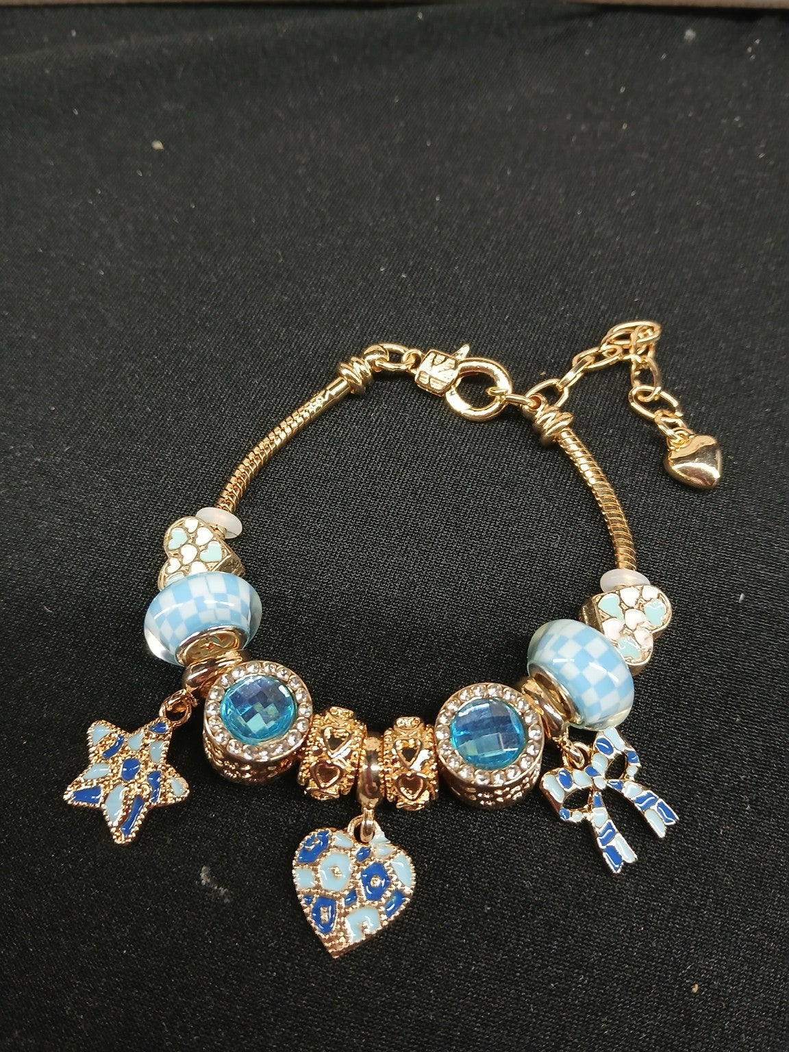 Close-up blue and gold charm bracelet