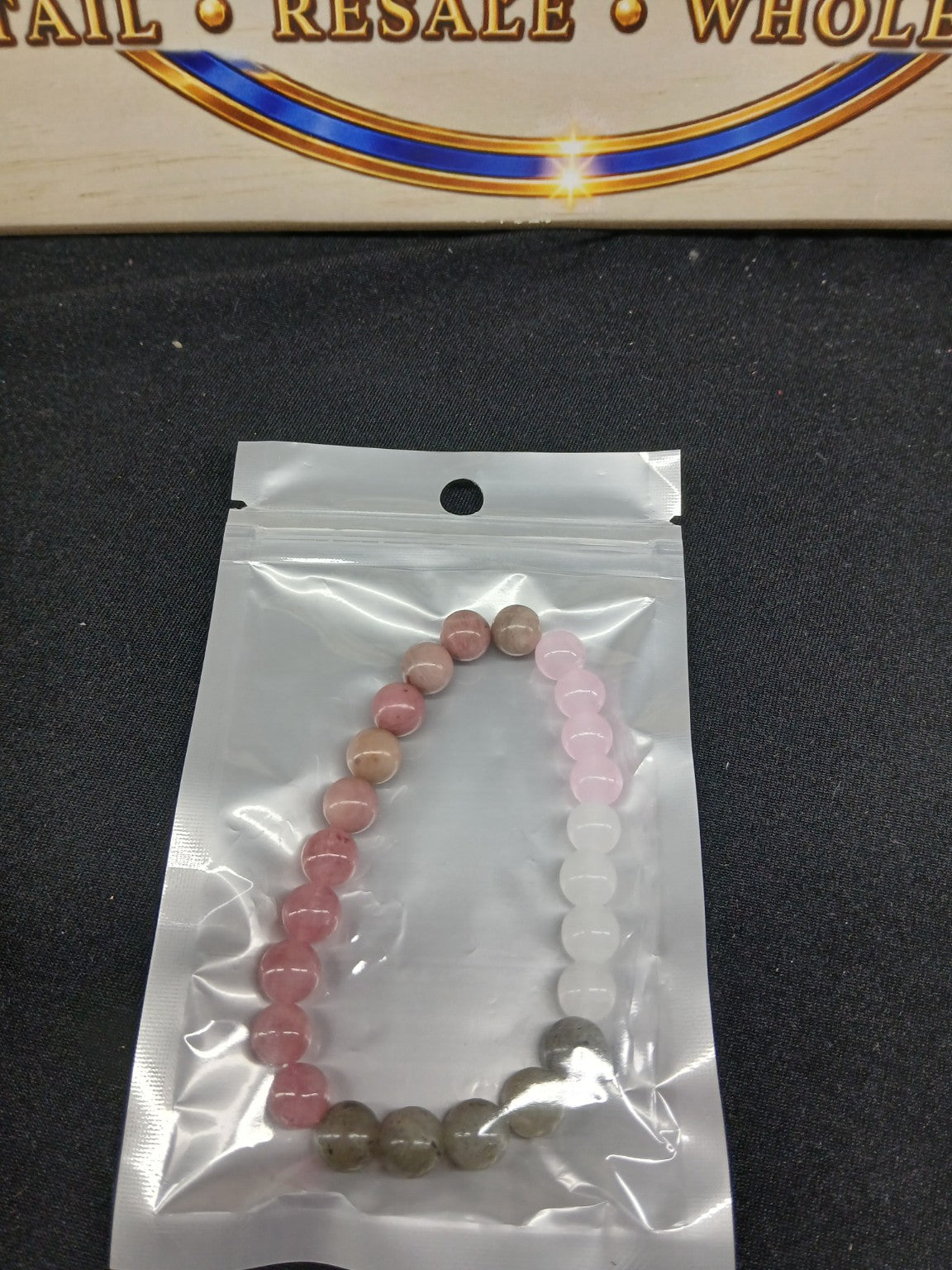 Pink white and gray beaded bracelet close-up