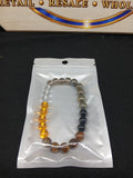 Amber clear and earth-tone beaded bracelet closeup