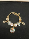 Good Vibes gold-tone charm bracelet closeup